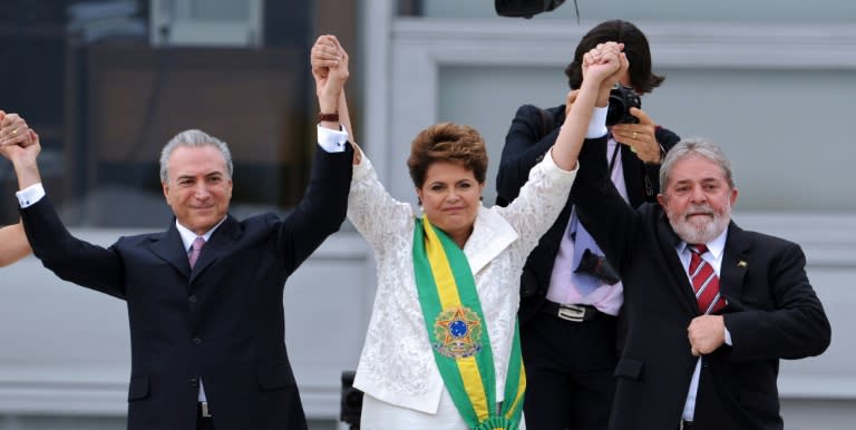 Newly sworn in Brazilian President Dilma Rousseff (C), her Vice-President Michel Temer (L) and Brazilian outgoing President Luiz Inacio Lula da Silva during the inauguration ceremony at the Planalto Palace in Brasilia on January 1, 2011