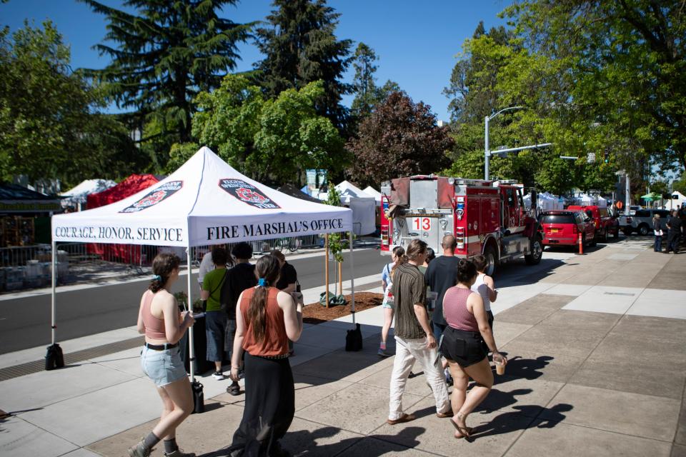 The Eugene-Springfield Fire Department staffs a booth at the Eugene Saturday Market Saturday, May 11, 2024 to raise awareness about wildfire preparedness during Wildfire Awareness Month.