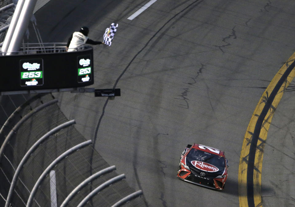 Christopher Bell gets the checkered flag as he drives to the finish line during the NASCAR Cup Series road-course auto race at Daytona International Speedway, Sunday, Feb. 21, 2021, in Daytona Beach, Fla. (AP Photo/Terry Renna)