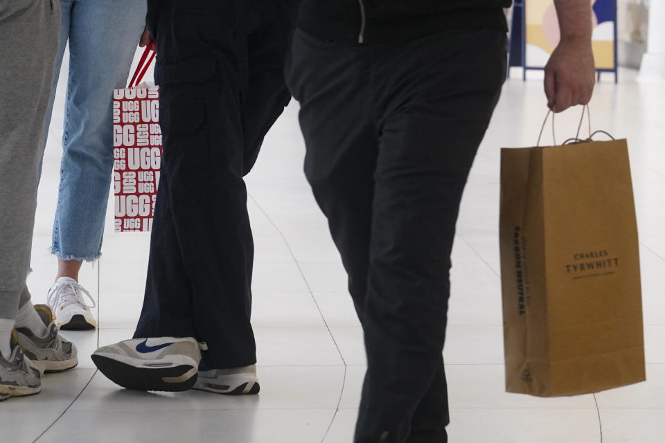 File - Shoppers hold their latest purchases while walking through the Oculus Center shopping mall, Tuesday June 6, 2023, in New York. Analysts who follow the retail industry estimate that the resumption of student loan payments could trim consumer spending by $14 billion a month or $305 per borrower. (AP Photo/Bebeto Matthews, File)