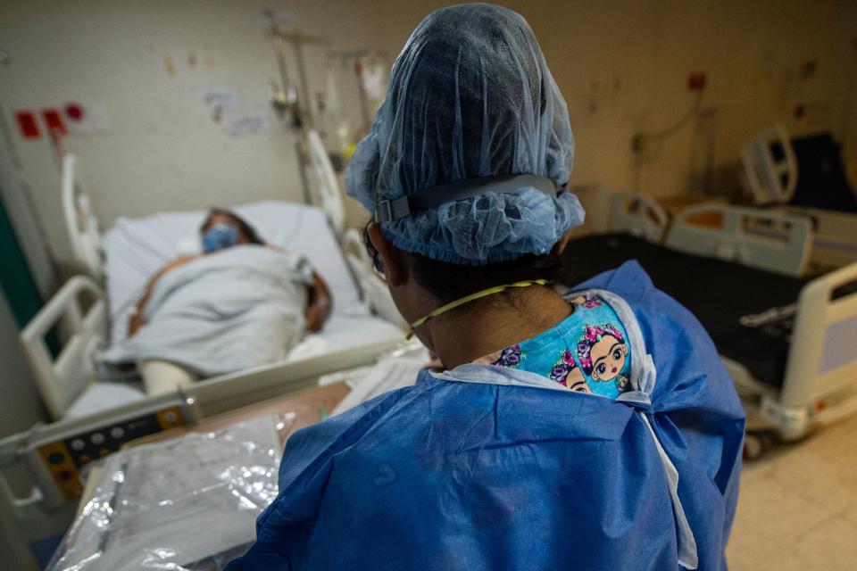 A health worker checks a patient at the COVID-19 zone of a hospital in Atizapan, Mexico, on May 22, 2020, amid the new coronavirus pandemic. (Photo by PEDRO PARDO / AFP) (Photo by PEDRO PARDO/AFP via Getty Images)