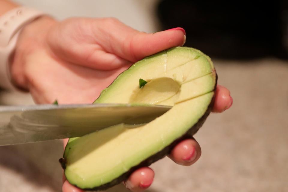 Anna Jones, a local dietician and nutritionist, slices an avocado to add to her heart healthy recipe, Friday Feb. 15, 2019. 