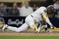 San Diego Padres' Jurickson Profar falls while batting during the eighth inning of a baseball game against the Colorado Rockies, Monday, May 13, 2024, in San Diego. (AP Photo/Gregory Bull)