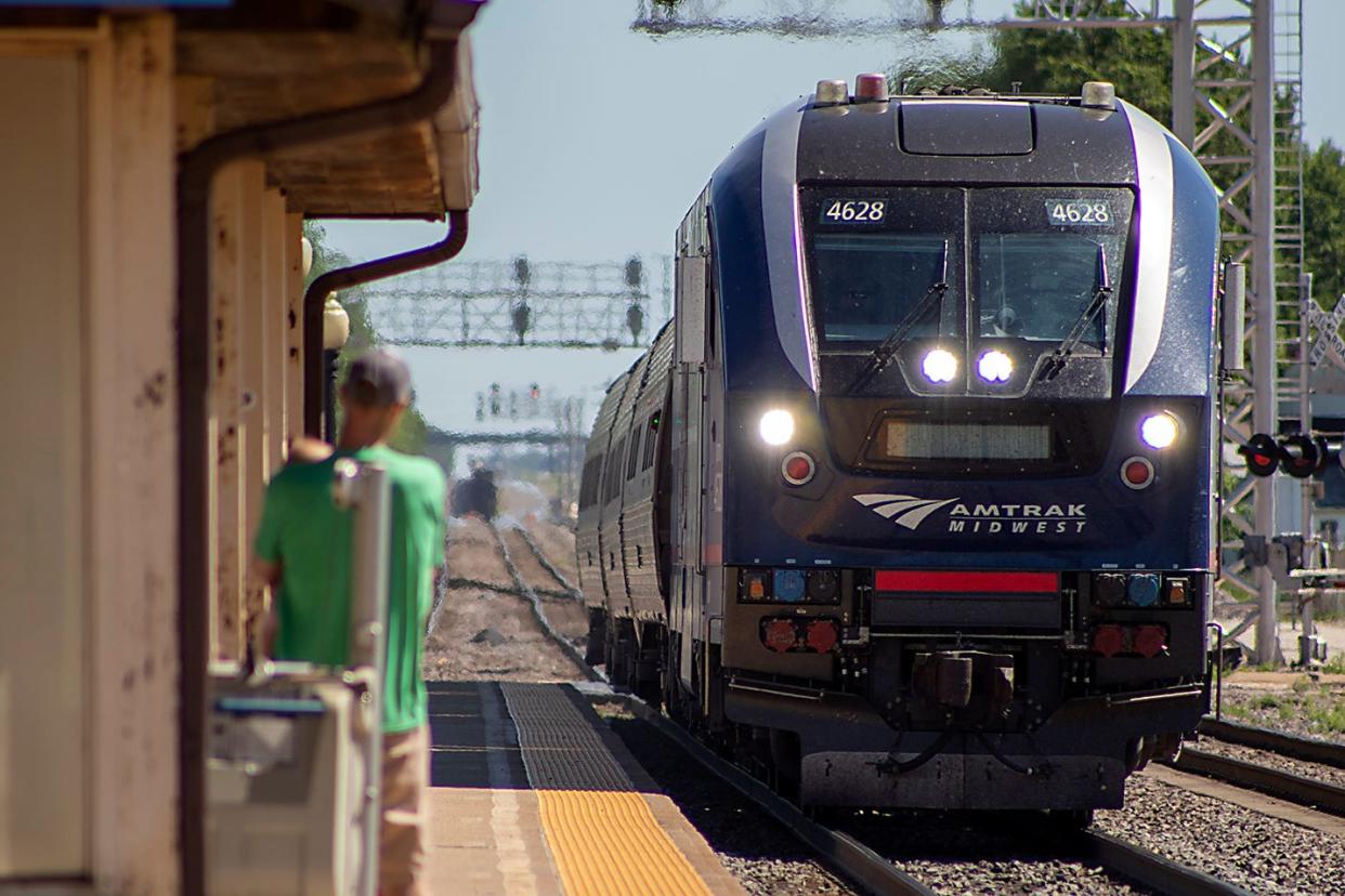 A traveler waits as the Carl Sandburg train arrives at the Galesburg Amtrak Depot on Saturday, June 18, 2022/