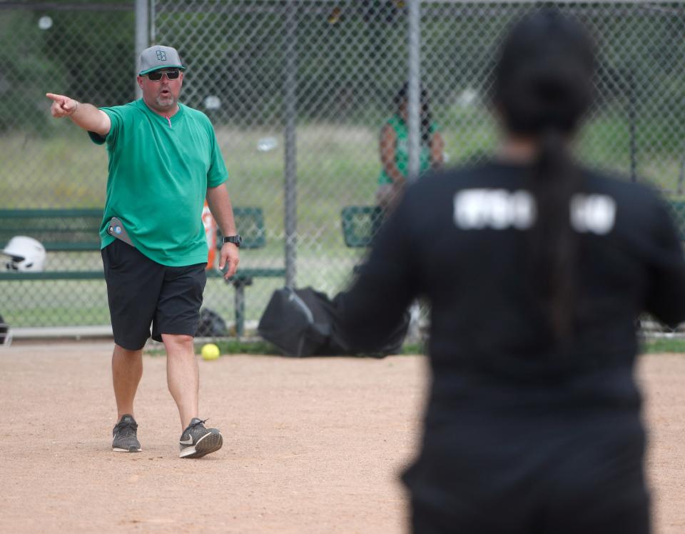 Coach Kevin Hermes speaks to his softball players during practice, Tuesday, May 21, 2019, in Banquete. Hermes is the head football coach for Banquete. 