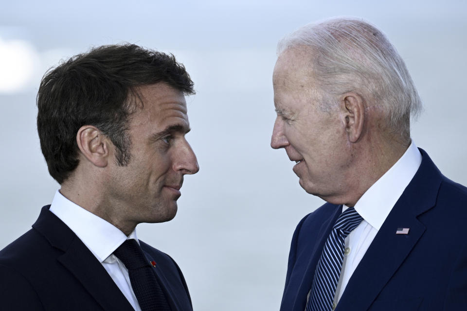 France's President Emmanuel Macron, left, speaks with U.S. President Joe Biden after a family photo of leaders of the G7 and invited countries during the G7 Leaders' Summit in Hiroshima, western Japan, Saturday, May 20, 2023. (Brendan Smialowski/Pool Photo via AP)