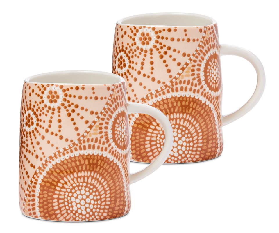 A set of two mugs painted in dark orange indigenous dots. 