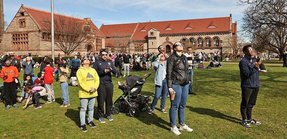 Hundreds gathered on the Thomas Crane Library lawn in Quincy to watch the solar eclipse on
Monday April 8, 2024