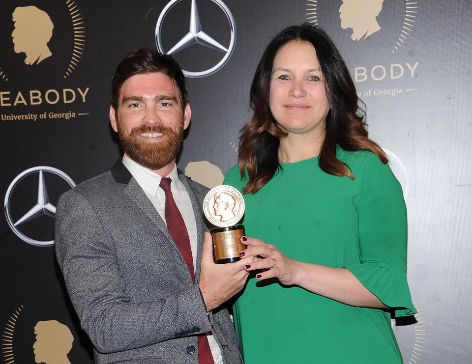 FILE - Andy Mills, left, and Rukmini Callimachi hold the award for their 2018 podcast “Caliphate” at the 78th annual Peabody Awards in New York on May 18, 2019. The New York Times says it was wrong to trust the story of a Canadian man whose claims of witnessing and participating in atrocities as a member of the Islamic State was a central part of its award-winning 2018 podcast “Caliphate.” The 12-part series won a Peabody Award and was a Pulitzer Prize finalist. But it began to unravel when Canadian authorities in September arrested Shehroze Chaudhry on charges of perpetrating a terrorist hoax. He was included in the podcast under the alias Abu Huzayfah. The Times said its journalists should have done a better job vetting him, and not included his story as part of the podcast. (Photo by Brad Barket/Invision/AP, FIle)