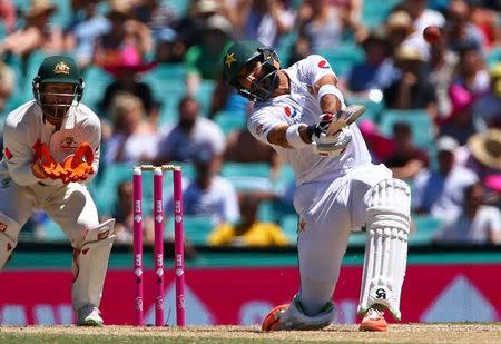 Cricket - Australia v Pakistan - Third Test cricket match - Sydney Cricket Ground, Sydney, Australia - 7/1/17 Pakistan's Sarfraz Ahmed hits a six as Australia's wicketkeeper Matthew Wade looks on. REUTERS/David Gray