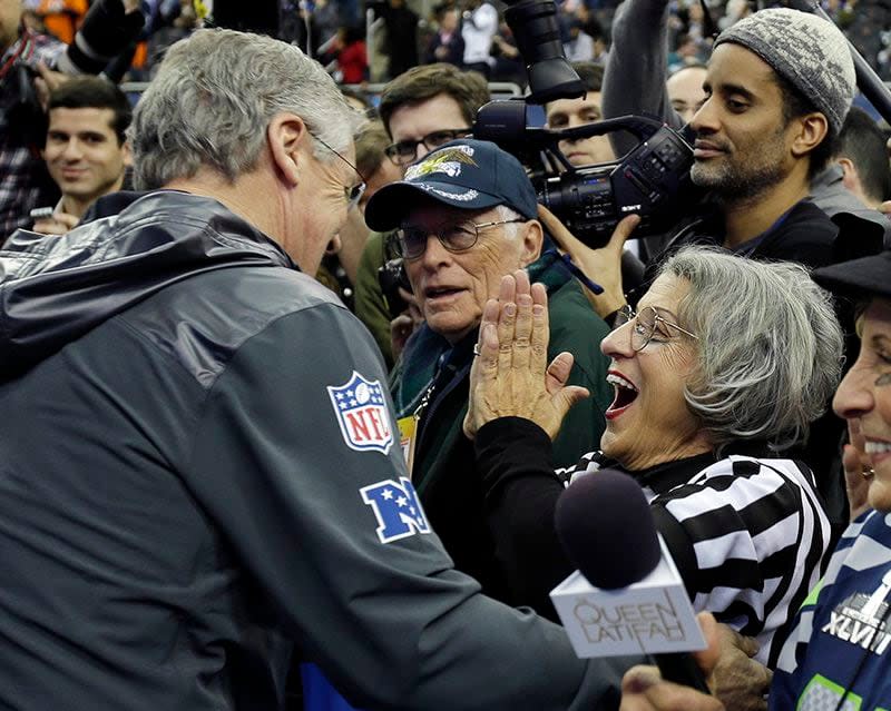 Seahawks fan Teresa Dahlquist reacts after getting a hug from Seattle head coach Pete Carroll during media day for the NFL Super Bowl XLVIII football game Tuesday, Jan. 28, 2014, in Newark, N.J.