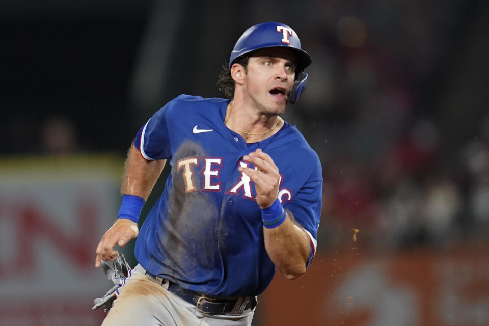 Texas Rangers' DJ Peters rounds second base as Nick Solak doubles during the fourth inning of a baseball game against the Los Angeles Angels Friday, Sep. 3, 2021, in Anaheim, Calif. (AP Photo/Ashley Landis)