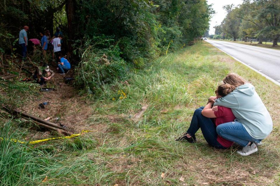 Baleigh Bowlin’s mother hugs a family member as they sit near the site of a car crash that killed her daughter off of Highway 613 in Hurley on Monday, Oct. 17, 2022. Baleigh Bowlin and Chloe Taylor were driving together after the East Central High School homecoming dance when their car went off the road.