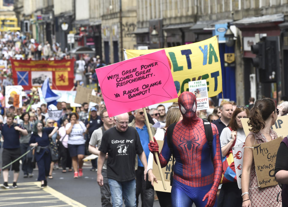 <p>Scotland United Against Trump demonstrators march through Edinburgh, Scotland, during a “Carnival of Resistance” to protest the visit of President Trump to the U.K., Saturday, July 14, 2018. (Photo: Lesley Martin/PA via AP) </p>