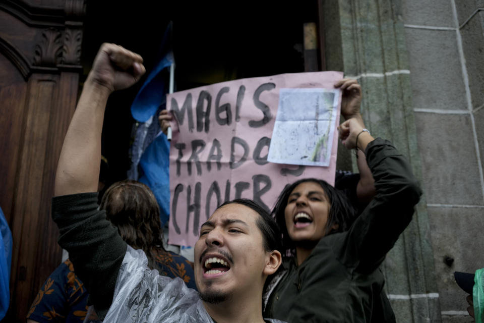 People protest in front of the Electoral Court building after Guatemala's highest court has suspended the releasing of official results of the June 25 general elections, in Guatemala City, Monday, July 3, 2023. (AP Photo/Moises Castillo)