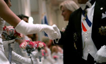 <p>A debutante greets a guest during the reception line ceremony at the 52nd International Debutante Ball, Dec. 29, 2006, at the Waldorf Astoria hotel in New York. Some 53 young women from nine countries made their formal debut at the annual ball where more than 2,000 women from 72 countries have been presented since 1954. (Photo: Mike Segar/Reuters) </p>