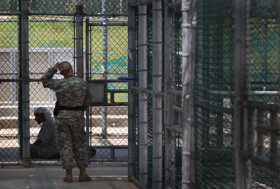 GUANTANAMO BAY, CUBA - MARCH 29: (EDITORS NOTE: Image has been reviewed by the U.S. Military prior to transmission.) A U.S. military prison guard watches over a detainee in the maximum security Camp 5 of the Guantanamo Bay detention center on March 29, 2010 in Guantanamo Bay, Cuba. U.S. President Barack Obama pledged to close the prison by early 2010 but the administration has struggled to transfer, try or release the remaining detainees from the facility, located at the U.S. Naval base on the Caribbean island. (Photo by John Moore/Getty Images)