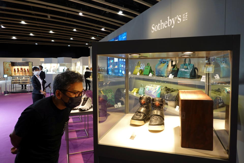 A visitor looks at a pair of 'Nike Air Yeezy 1' prototype sneakers designed by Kanye West, before the sneakers go up for private sale at Sotheby's, at the Hong Kong Convention and Exhibition Centre, in Hong Kong, China April 16, 2021. REUTERS/Joyce Zhou