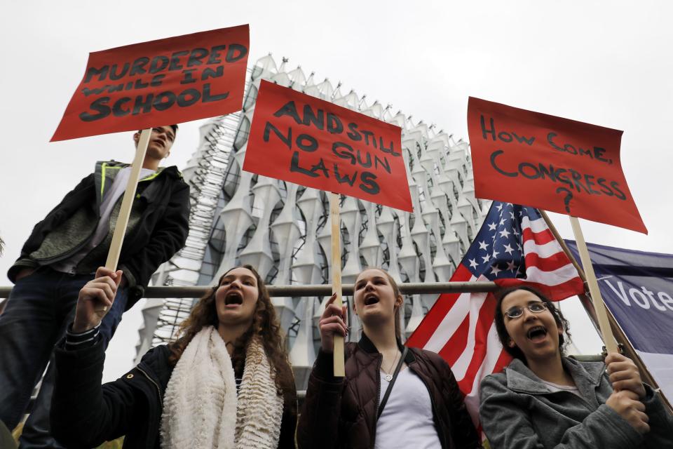 <p>Protestors carry placards and shout slogans during a demonstration calling for stricter gun control outside the U.S. Embassy in south London on March 24, 2018. The London rally, in solidarity with the March For Our Lives rallies in the U.S., is one of hundreds of gun control protests taking place globally. (Photo: Tolga Akmen/AFP/Getty Images) </p>