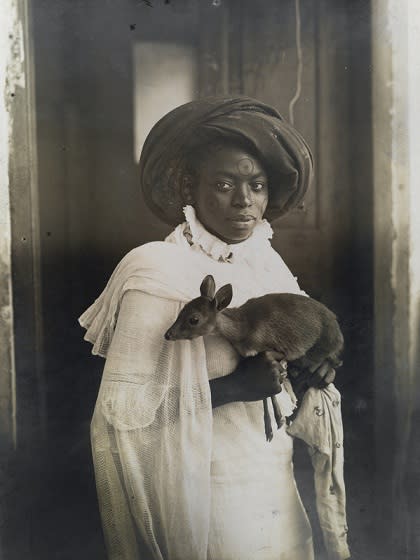 'A young Kenyan woman holds her pet deer, Mombasa, Zanzibar, Kenya, Africa.' (Underwood & Underwood/The National Geographic/Christie’s Images) <br> <br> <a href="https://www.christies.com/services/publications/browse-ecatalogues.aspx" rel="nofollow noopener" target="_blank" data-ylk="slk:Click here to see the full collection at Christie's;elm:context_link;itc:0;sec:content-canvas" class="link ">Click here to see the full collection at Christie's</a>