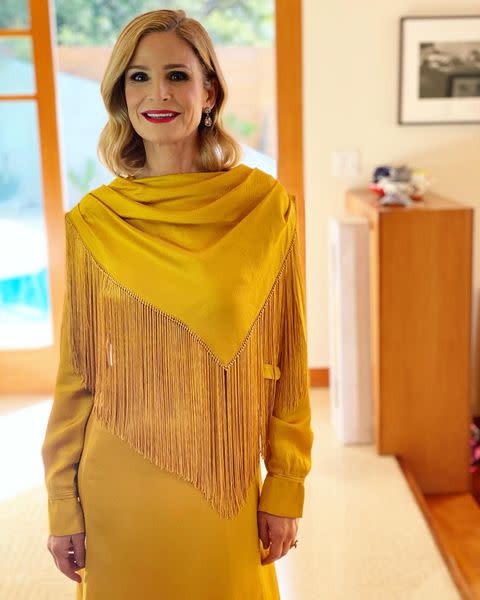 <p>presents in a golden Gabriela Hearst gown featuring fringe detailing, plus Fred Leighton jewelry. </p>