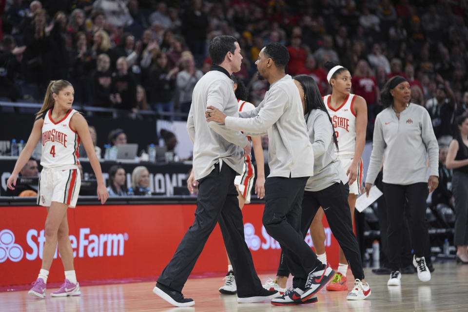 Ohio State head coach Kevin McGuff, center left, is held back by assistant coaches after receiving a technical foul during the second half of an NCAA college basketball quarterfinal game against Maryland at the Big Ten women's tournament Friday, March 8, 2024, in Minneapolis. Maryland upsets No. 3 Ohio State 82-61. (AP Photo/Abbie Parr)