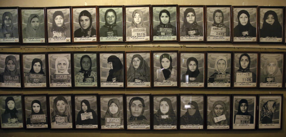 In this Monday, Jan. 7, 2019 photo, mug shots of former prisoners hang on the wall at a former prison run by the pre-revolution intelligence service, Savak, now a museum, in downtown Tehran, Iran. Wax mannequins silently portray the horrific acts of torture that once were carried out within its walls. As Iran marks the 40th anniversary of its Islamic Revolution and the overthrow of the shah, those who suffered torture at the hands of the police and dreaded SAVAK intelligence service still bear the scars. (AP Photo/Ebrahim Noroozi)