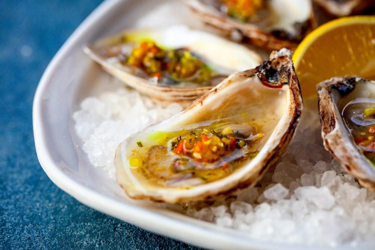 At Stage Kitchen, raw oysters get a luxe touch from a truffle, turmeric and yuzu mignonette.