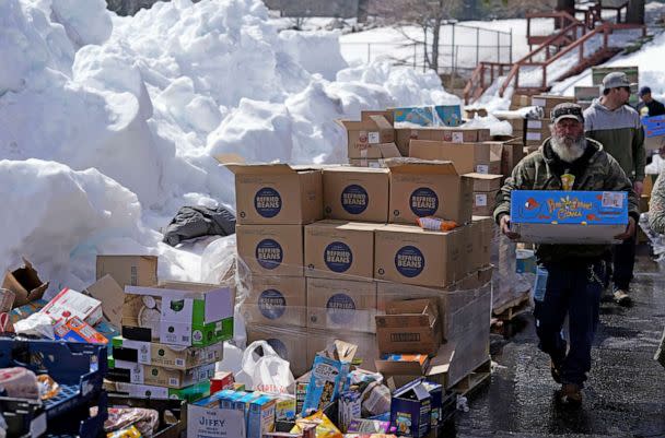 PHOTO: Food is distributed out of a parking lot after a series of storms, March 8, 2023, in Crestline, Calif. (Marcio Jose Sanchez/AP)