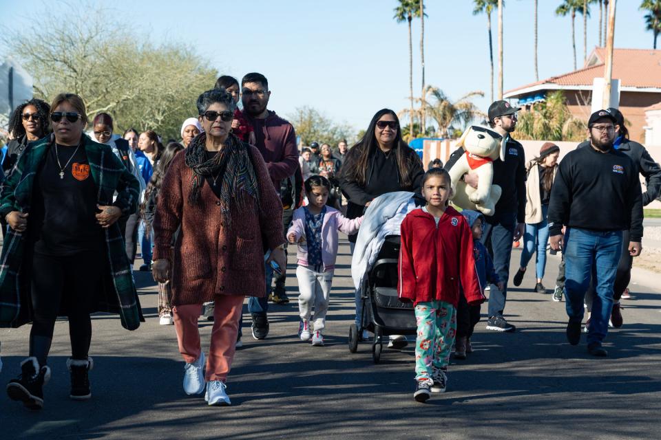A crowd of people, including students, parents, teachers, and alumni gather for a march through the neighborhood surrounding Martin Luther King Jr. Elementary School on Jan. 13, 2024, in Phoenix.