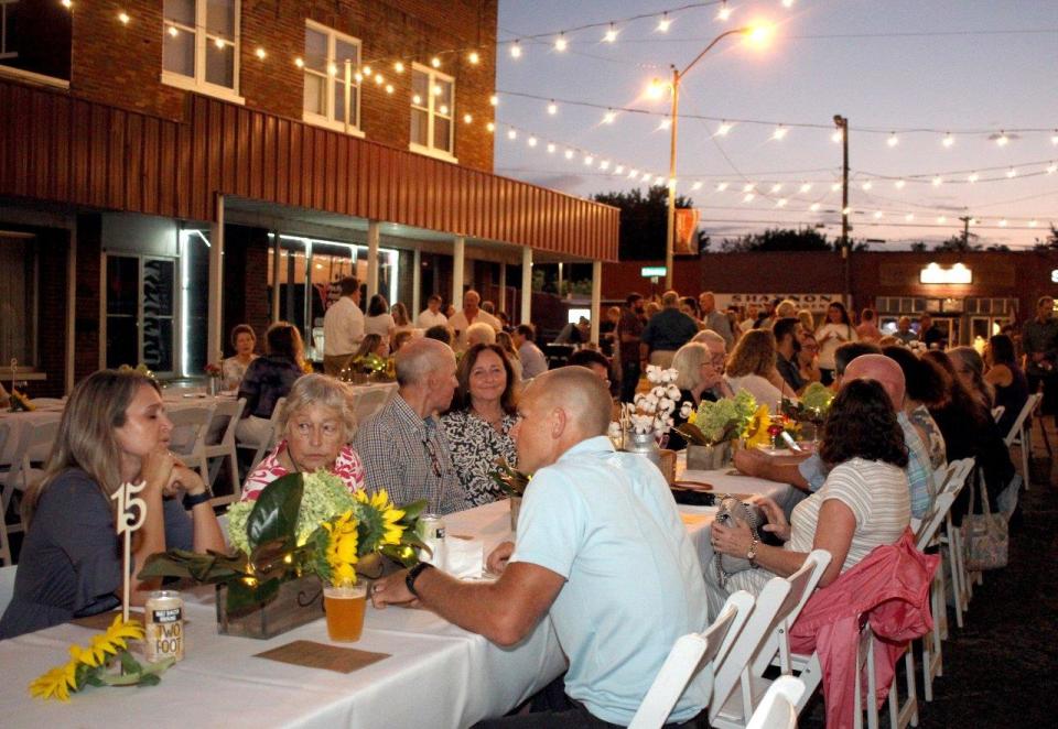 Folks sit down as they attend the 5th Annual Farm to Table Dinner in Portland, Tenn., on Saturday, August 28, 2021.