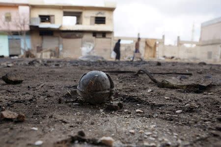 An unexploded cluster bomblet is seen along a street after airstrikes by pro-Syrian government forces in the rebel held al-Ghariyah al-Gharbiyah town, in Deraa province, Syria February 11, 2016. REUTERS/Alaa Al-Faqir