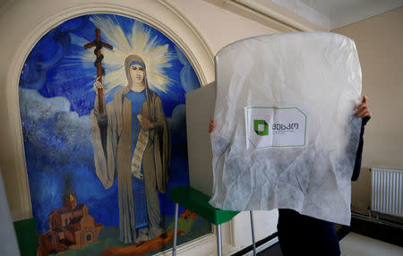 An election official prepares a polling station located in a public school ahead of the parliamentary elections in Tbilisi, Georgia, October 7, 2016. REUTERS/David Mdzinarishvili