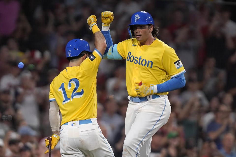 Boston Red Sox's Triston Casas, right, celebrates with Connor Wong (12) as he returns to the dugout after scoring on his home run in the seventh inning of a baseball game against the Atlanta Braves, Wednesday, July 26, 2023, in Boston. (AP Photo/Steven Senne)