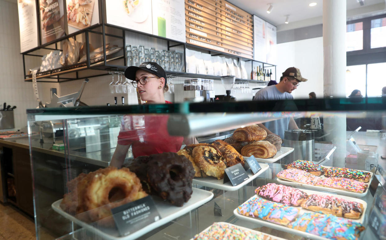 Store manager Taylor Venning, left, works in the cafe at Foxtrot (John J. Kim/Chicago Tribune / Getty Images)