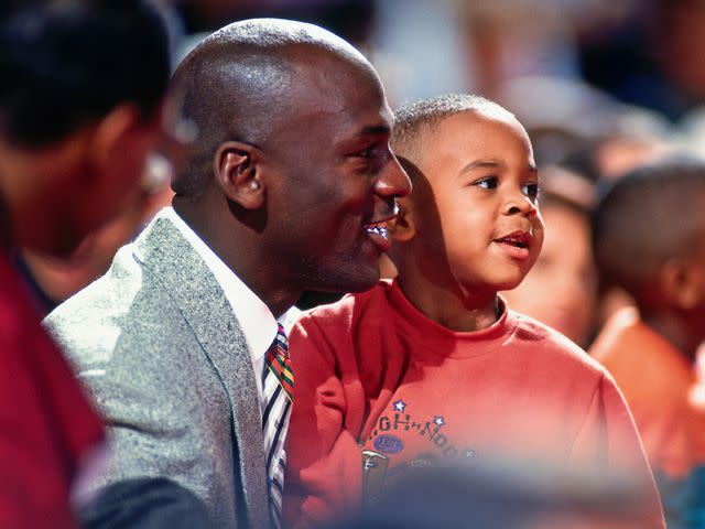 <p>Andrew D. Bernstein/NBAE/Getty</p> Michael Jordan and his son Marcus Jordan before the game against the Miami Heat on November 6, 1993 in Chicago, Illinois