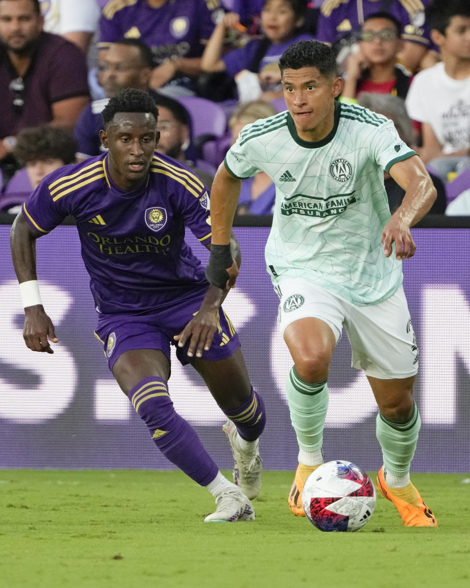 Atlanta United defender Ronald Hernandez, right, moves the ball past Orlando City forward Ivan Angulo during the first half of an MLS soccer match, Saturday, May 27, 2023, in Orlando, Fla. (AP Photo/John Raoux)