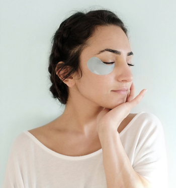 a model wearing the blue under eye patches