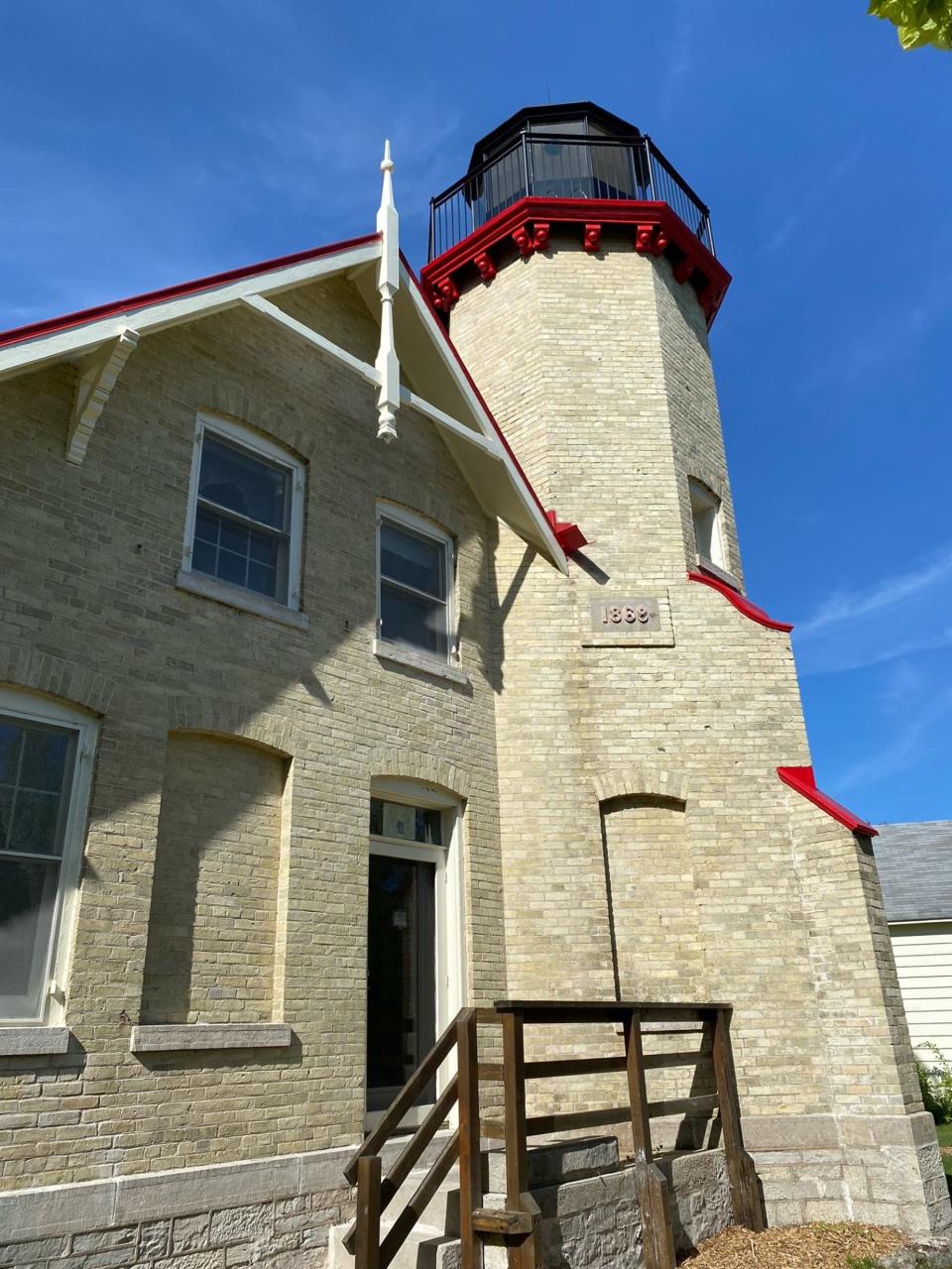 This photo shows restoration done on the brick and numbered placard at the McGulpin Point Lighthouse in Mackinaw City.