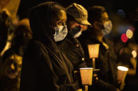 People gather for Kevin Peterson Jr., who was killed in Thursday's shooting with police involved, at a candlelight vigil in Vancouver, Wash., Friday, Oct. 30, 2020. The Clark County Sheriff's office has not released any details on the Thursday evening shooting in Hazel Dell, but a man told The Oregonian/OregonLive that his 21-year-old son was fatally shot by police. (AP Photo/Paula Bronstein)