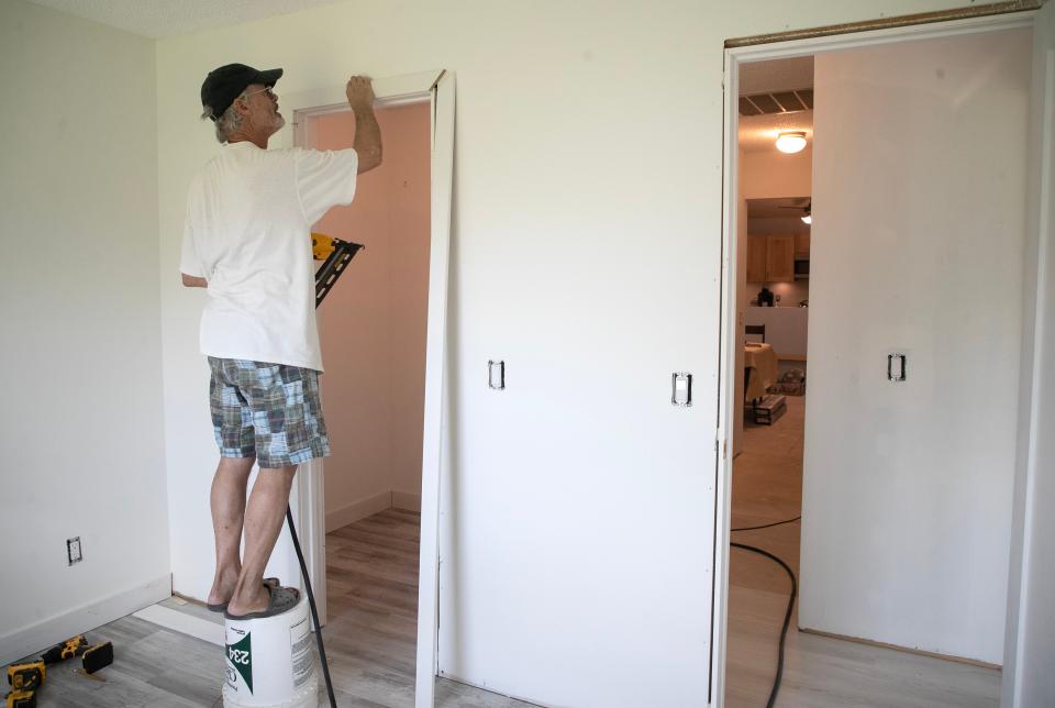 David Bormuth installs trim on a bedroom closet in his condo off Island Park Road in Fort Myers on Thursday, Sept. 21, 2023. He's been doing the work himself after the company hired by his HOA stopped working after only installing the sub-floors. Some other residents also got drywall installed.