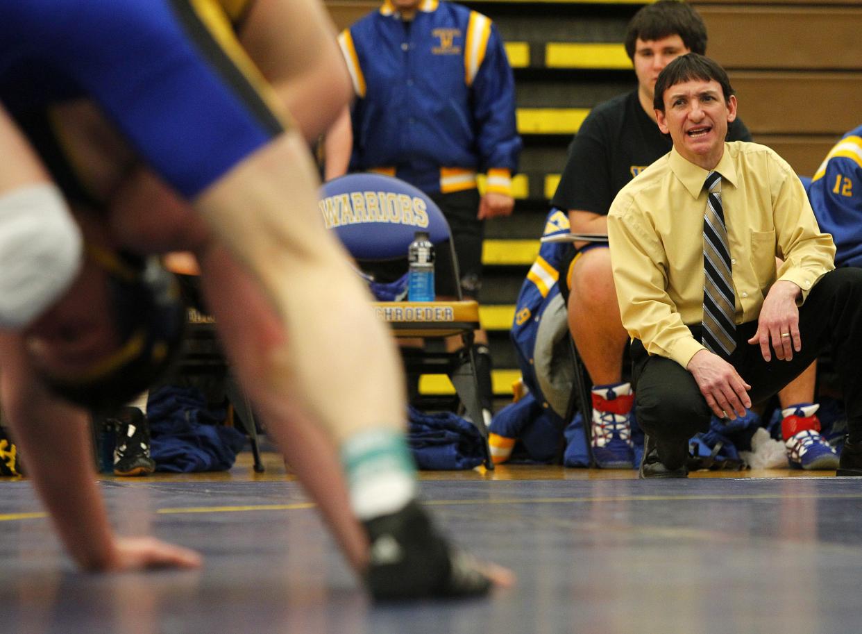Schroeder's head coach Dean Salvaggio, right, watches a match during a dual meet between cross town rivals the Webster Schroeder Warriors and the Webster Thomas Titans in Webster Wednesday evening, January 4, 2012.
(Democrat and Chronicle staff photo by Kris J. Murante, (1/4/2012)