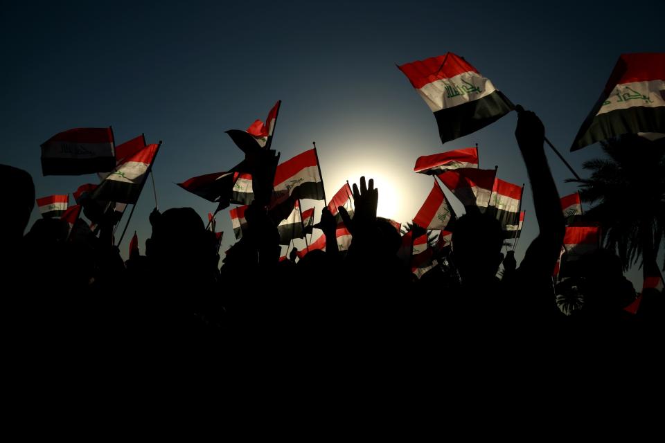 FILE - Followers of a political movement called the Al-Fateh Alliance chant during a rally before the parliamentary elections in Baghdad, Iraq, Thursday, Oct. 7, 2021. Eight months after national elections, Iraq still doesn't have a government. Driven by cutthroat competition for power and resources between elites, there is no clear way out of the unprecedented impasse. (AP Photo/Hadi Mizban, File)