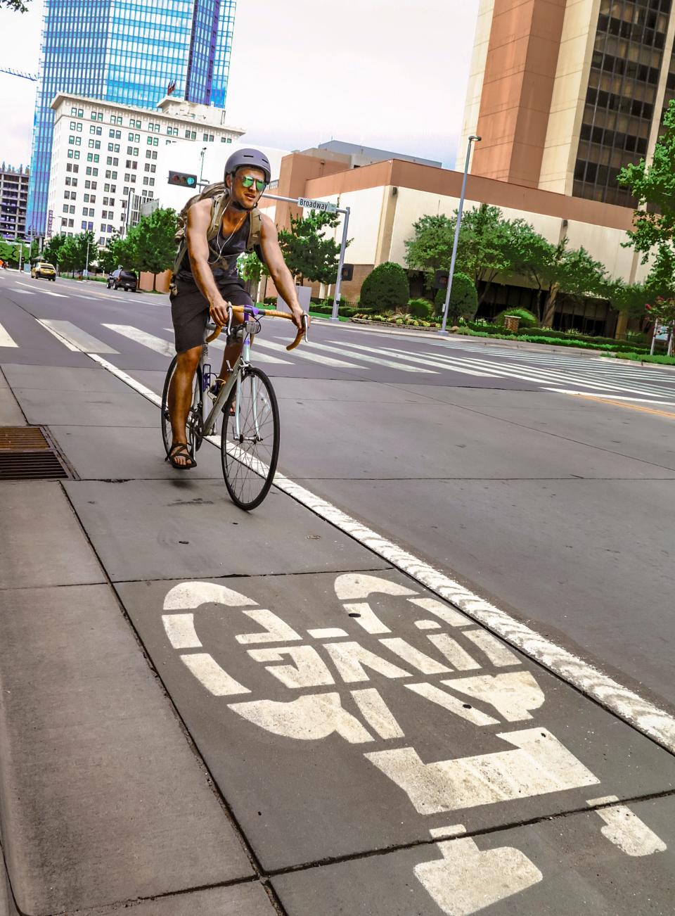 Juston McKinnon rides in the bike lane on Sheridan Avenue in downtown Oklahoma City on Thursday. [Photo by Chris Landsberger, The Oklahoman]