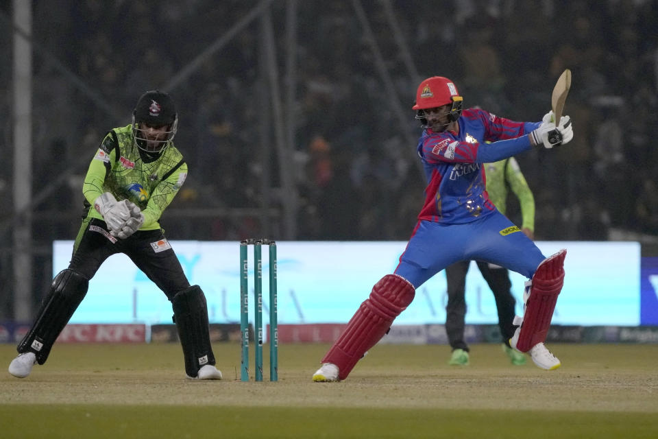 Karachi Kings' Shoaib Malik, right, plays a shot as Lahore Qalandars' Shai Hope watches during the Pakistan Super League T20 cricket match between Lahore Qalandars and Karachi Kings, in Lahore, Pakistan Saturday, Feb. 24, 2024. (AP Photo/K.M. Chaudary)