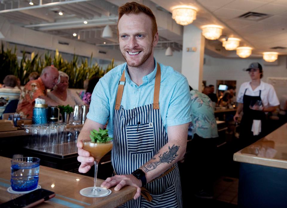 An Old Cuban cocktail is served at the bar at the new AquaGrille restaurant in Juno Beach. Bartender Peabo Powell makes the drink by mixing aged rum, lime, falernum syrup, mint, bitters and sparkling wine.