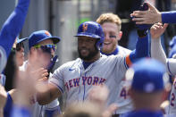 New York Mets' Starling Marte celebrates in the dugout after hitting a home run during the sixth inning of a baseball game against the Los Angeles Dodgers in Los Angeles, Saturday, April 20, 2024. Zack Short and Brandon Nimmo also scored. (AP Photo/Ashley Landis)