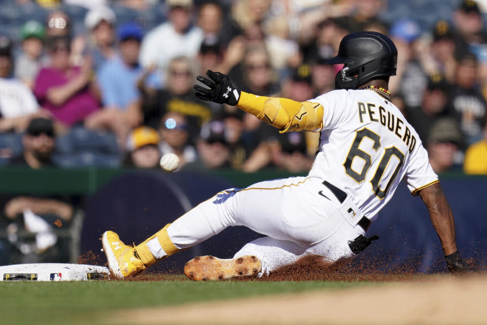 Pittsburgh Pirates' Liover Peguero slides into third base with a triple against the Miami Marlins during the second inning of a baseball game in Pittsburgh, Sunday, Oct. 1, 2023. (AP Photo/Matt Freed)