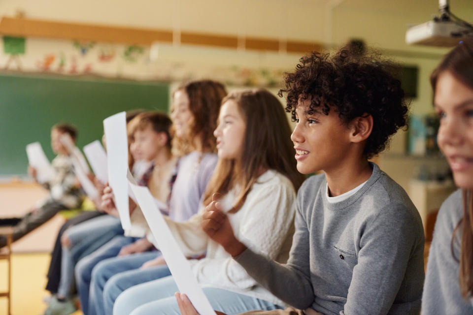 students reading off a paper