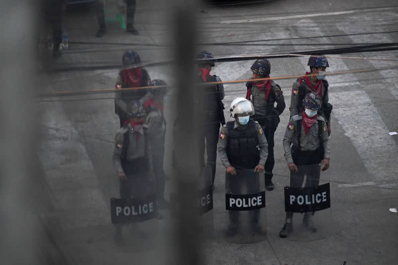 Police stand after they seized Sanchaung district in search of anti-coup demonstrators in Yangon